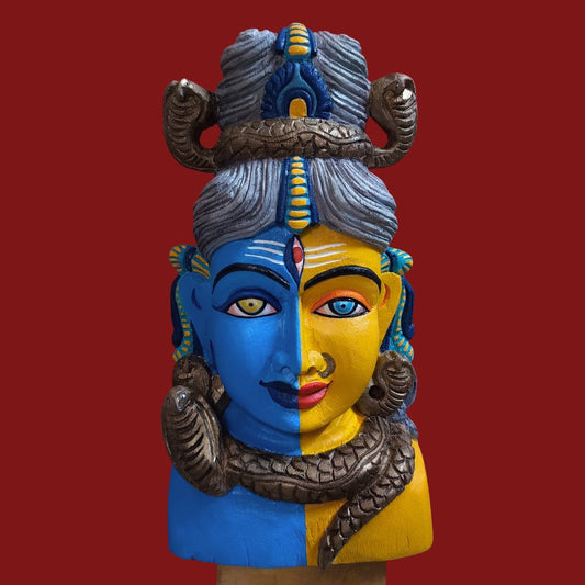 ardhanarishvara wooden artifact representing lord shiva in blue color and parvati devi in yellow color