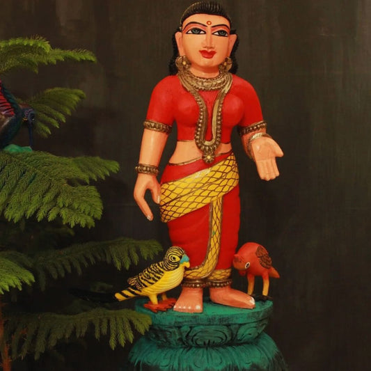 sita devi wooden artifact in a blessing stance wearing red saree with birds near her legs