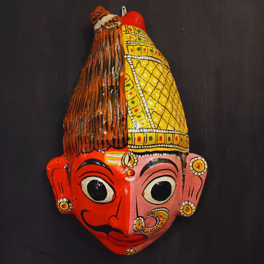 ardhanareshwara cheriyal mask in red and pink color combination represents lord shiva and parvati devi