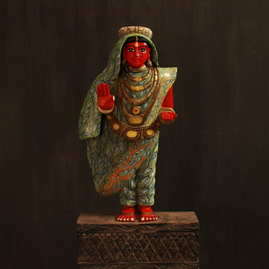 hand crafted bhudevi wooden artifact in a stance of blessing and her dress is adorned and with leaves