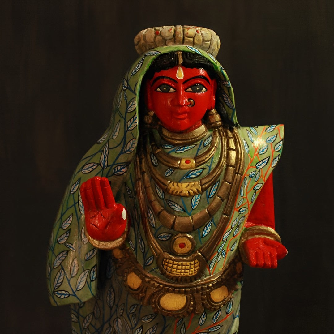 hand crafted bhudevi wooden artifact in a stance of blessing and her dress is adorned and with leaves