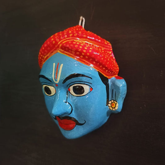 classic male cheriyal mask with blue color face wearing red turban