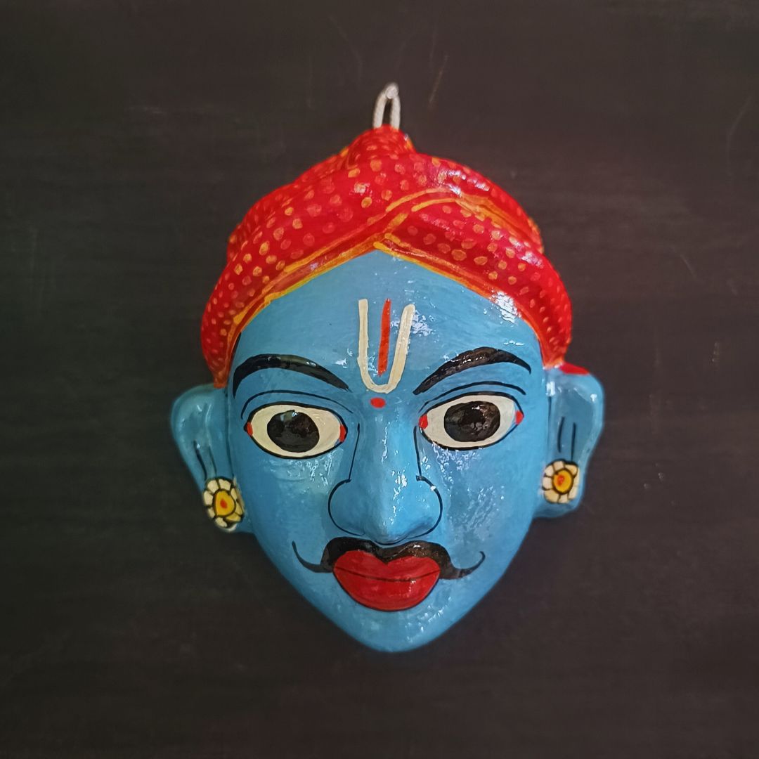classic male cheriyal mask with blue color face wearing red turban