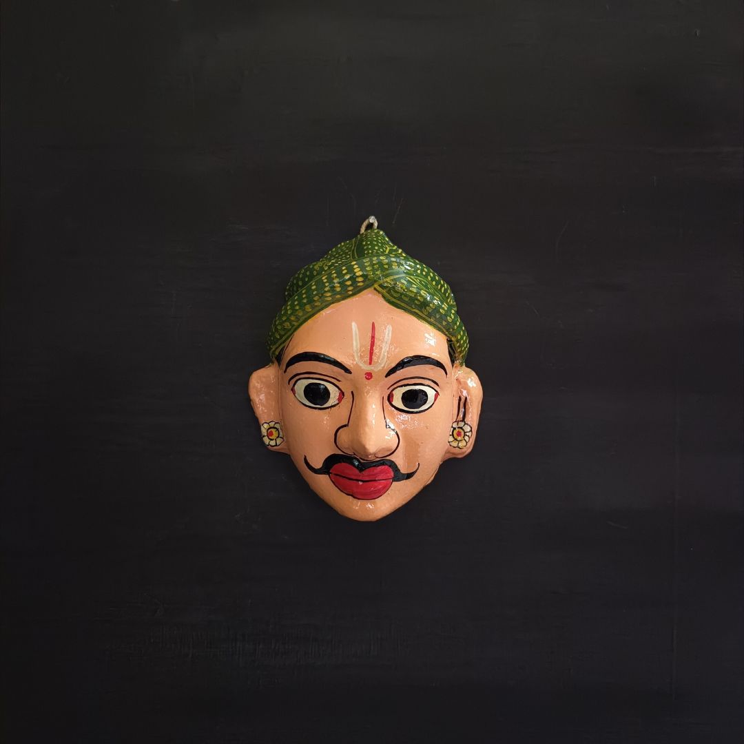 classic male cheriyal mask with light pink color face wearing green turban