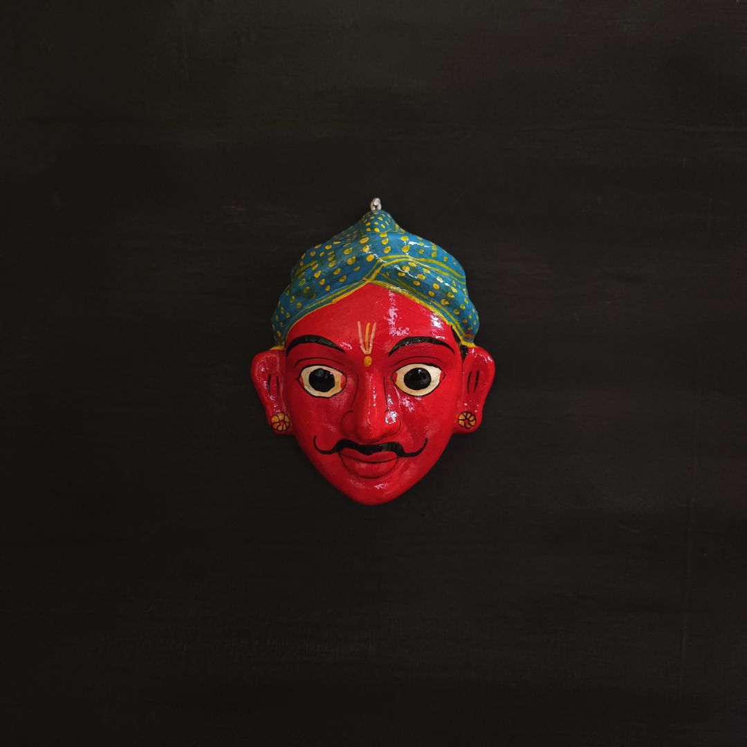 classic male cheriyal mask with red color face wearing blue turban