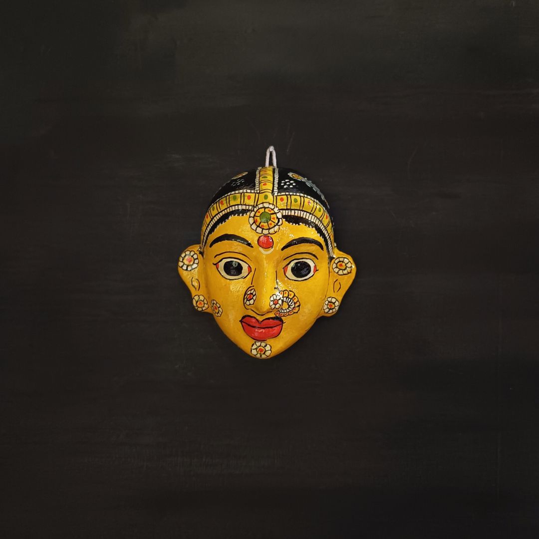 classic female cheriyal mask with yellow color face wearing ornaments