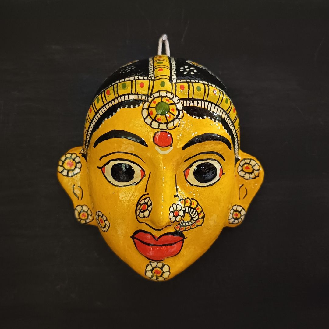 classic female cheriyal mask with yellow color face wearing ornaments