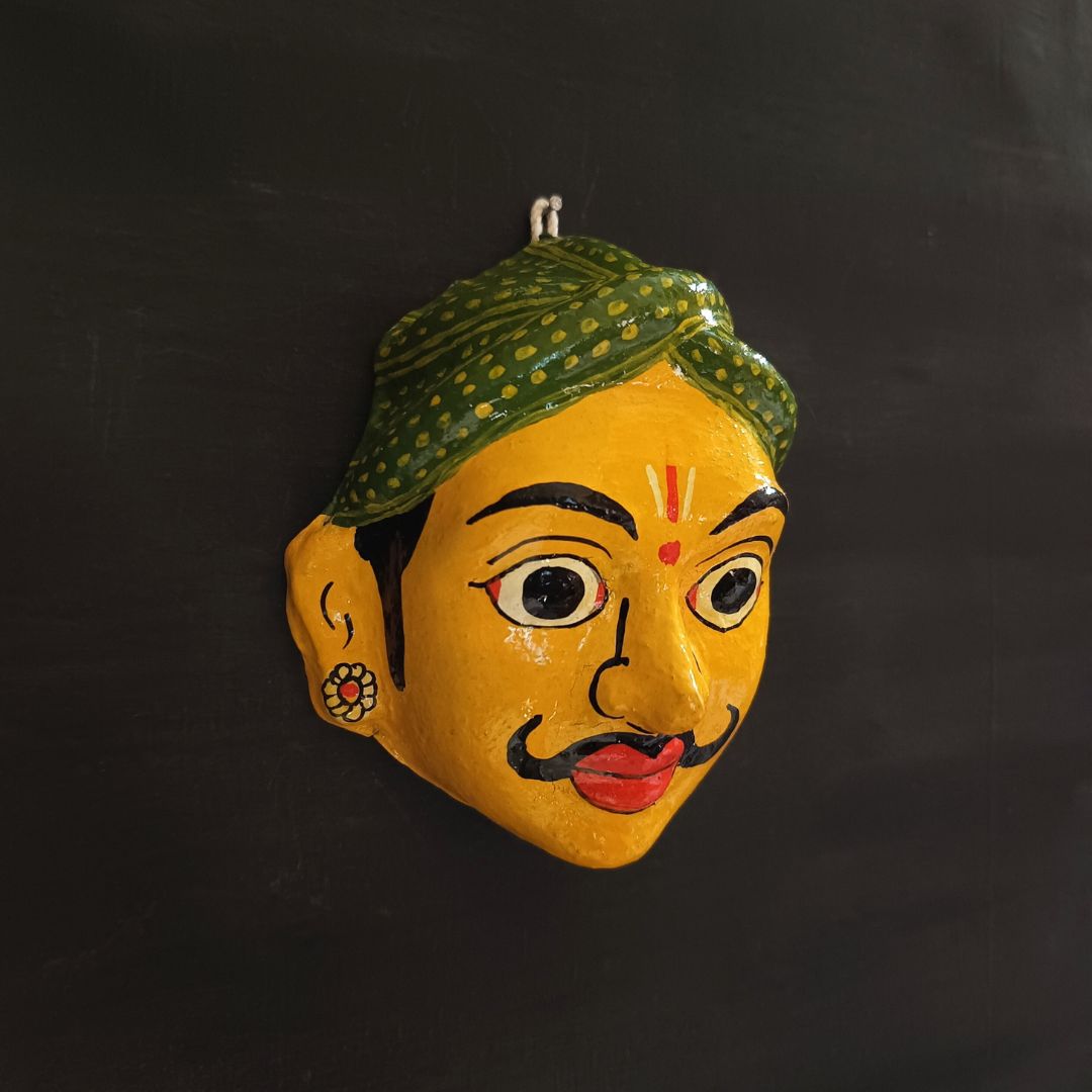 classic male cheriyal mask with yellow color face wearing green turban