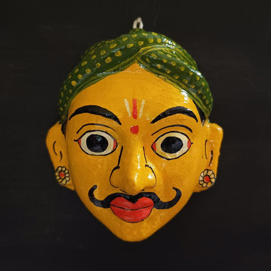 classic male cheriyal mask with yellow color face wearing green turban