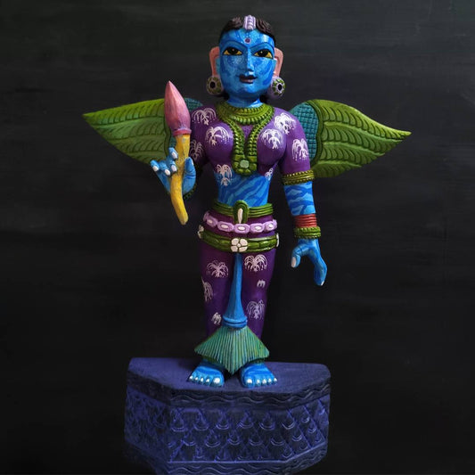 handcrafted teak wooden artifact of eywa from avatar in blue purple and green attire