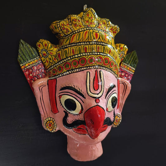 crowned garuda cheriyal mask in light pink color face with traditional and vintage look