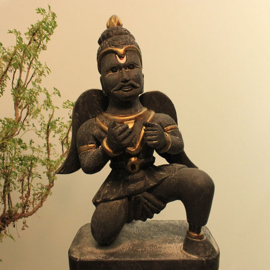 a black color garuda with wings in a sitting position painted in matte black finish