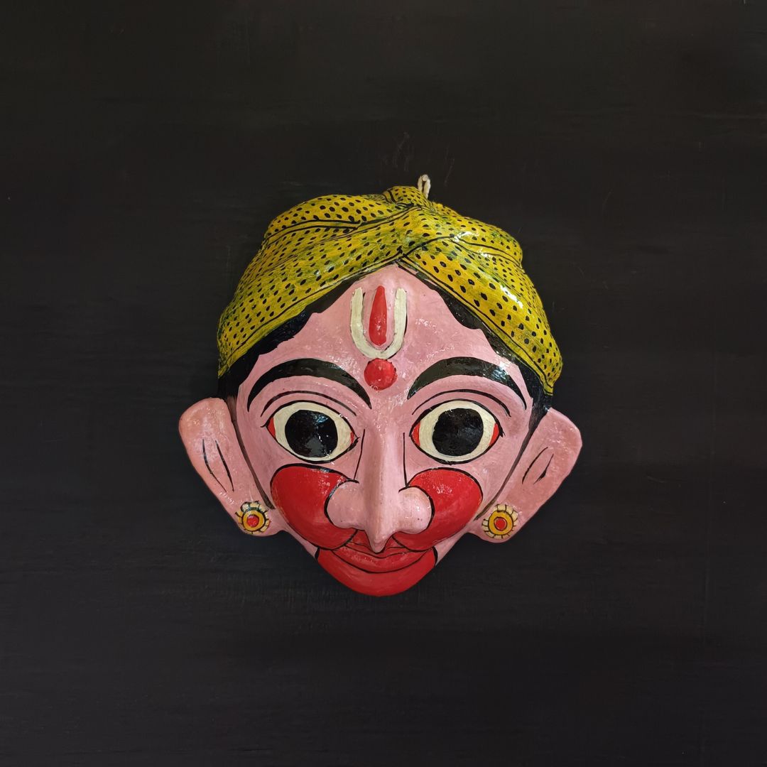 classic hanuman cheriyal mask with light pink color face wearing light green turban