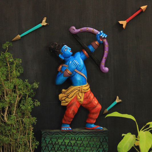 wooden artifact of lord ram in a stance of holding a bow and shooting arrow 