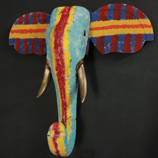 wooden elephant head with tusks is painted with textures giving it a modern look